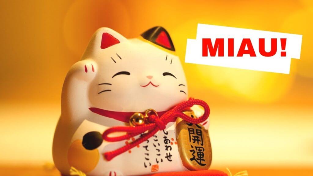 Kot z machającą łapką